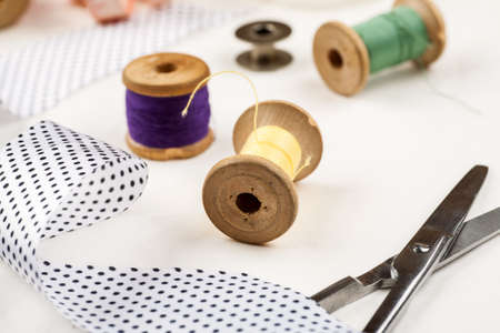 Set of tools and accessories for sewing and needlework with threads in spools, needles, measuring...