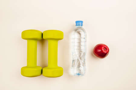 Sports equipment with bottle of water and red apples top viewの写真素材