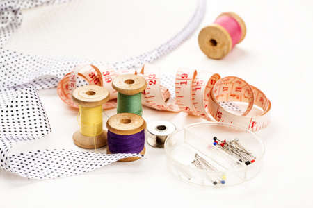 Set of tools and accessories for sewing and needlework with threads in spools, needles, measuring...