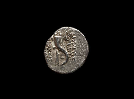 Ancient silver coin isolated on blackの写真素材