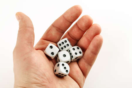 Male hand with white dice in it