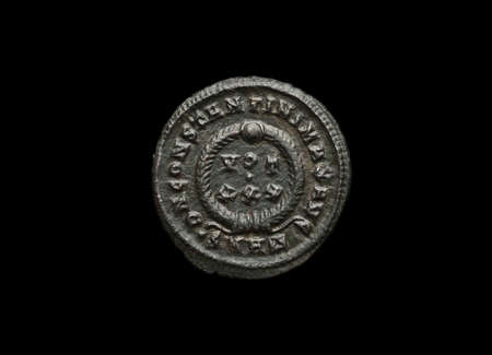 Ancient roman coin isolated on blackの写真素材