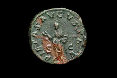 Ancient roman coin isolated on blackの写真素材