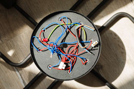 Chandelier with wires on the floor, preparation to installation