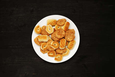 Traditional oriental cookies with sesame on a black table, top viewの写真素材
