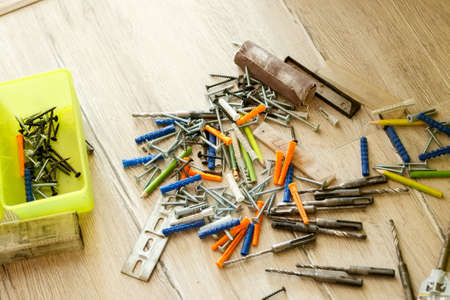 Pile of dowels and screws on the floor, close-upの写真素材