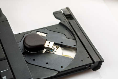 Usb flash drive inside open cd tray of laptop