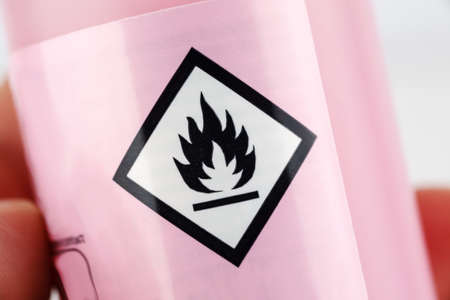 Flammable sign on a bottle, macro shotの写真素材
