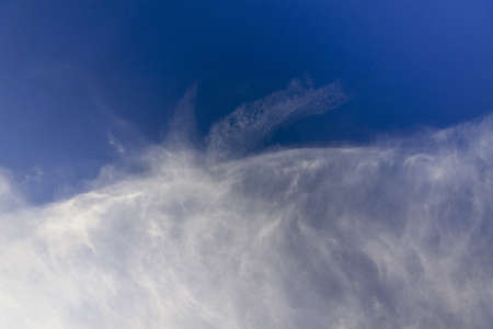 Sky texture with half of the sky blue and the other half in cloudsの写真素材