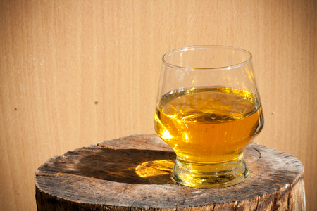 whiskey with wood backgroundの写真素材