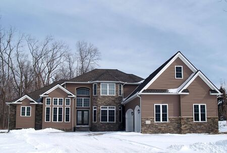 A newly constructed large home in a suburban developmentの写真素材