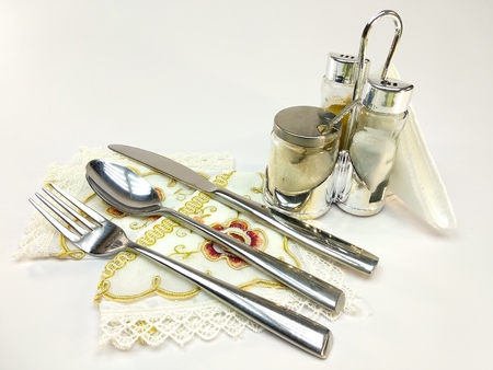 Empty served restaurant table with white tablecloth