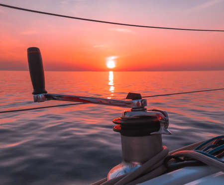 Red and orange sunset on the yachtの写真素材
