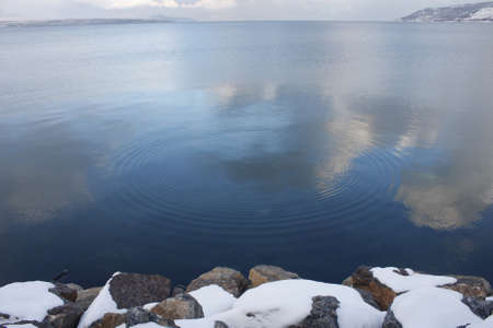 Blue circle water ripple with clouds reflectionの写真素材