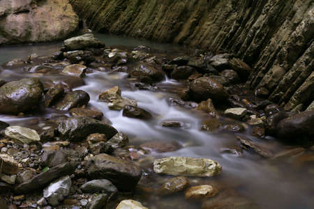 The stream runs between stones and rocks
