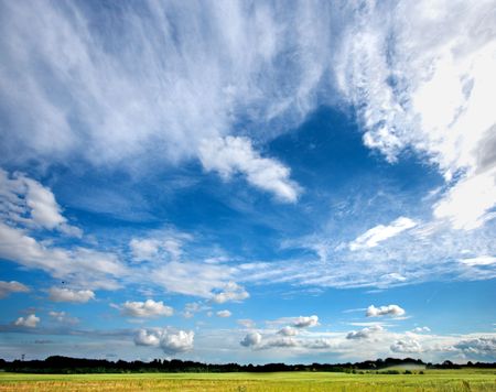 A photo of the blue, cloudy sky at the countrysideの写真素材