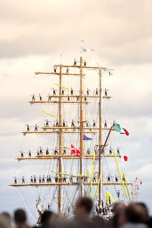 A telephoto of sailors getting the ship ready to sail