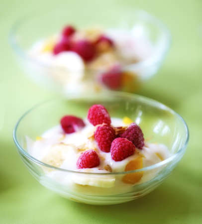 A photo of dessert - raspberries, banana and creamの写真素材