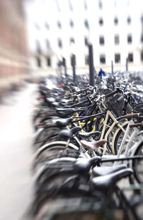 A lens blurred photo of lots of parked bikes. Symbolic content.の写真素材