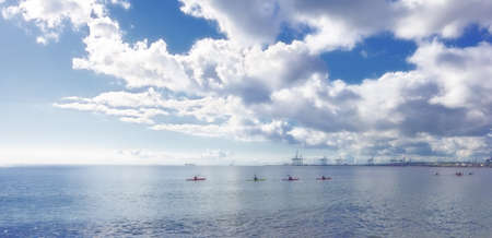 young people kayaking on the oceanの写真素材