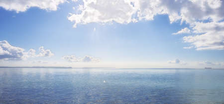 An early morning photo of young people kayaking on the oceanの写真素材