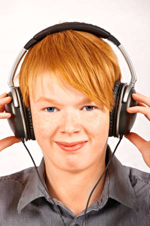 boy listening to music in headphones - isolated on white sの写真素材