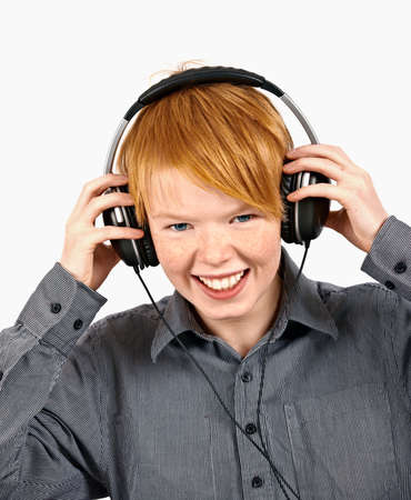 boy listening to music in headphones - isolated on white sの写真素材