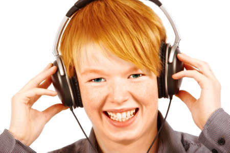 white boy listening to music in headphones - isolated on white backgroundの写真素材
