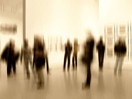 A motion blurred image of people at an exhibition
