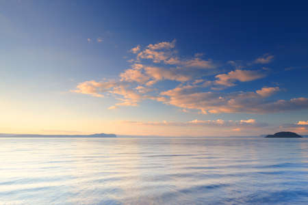 A photo of Sunset a calm day by the sea in New Zealandの写真素材