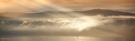 A photo of Sunset, ocean and mountainsの写真素材