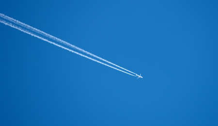 A  photo of an airplane high in the skyの写真素材