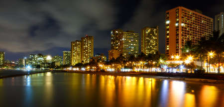 A nigh photo of Waikiki hotels and beach skylinesの写真素材