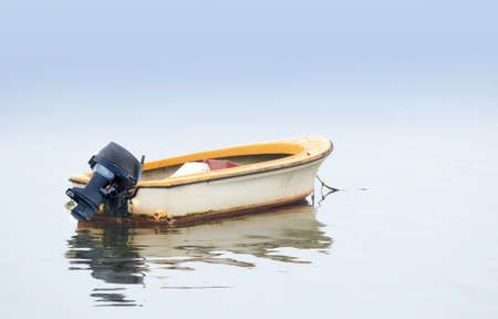 A photo of Small boat an early foggy morningの写真素材