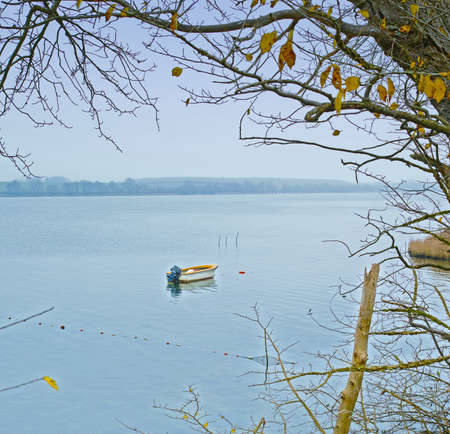 A photo of Small boat an early foggy morningの写真素材