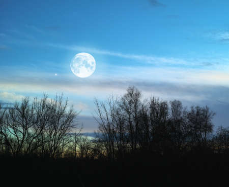 A photo of the full moon at nightの写真素材