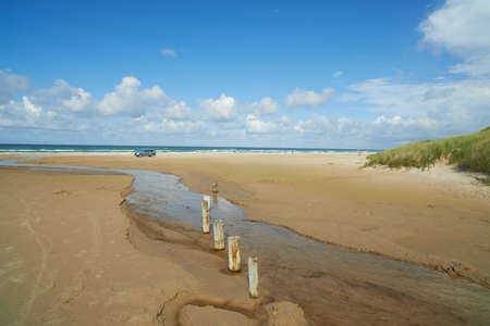 A photo a small creek running out in the ocean, Jutland, Denmarkの写真素材