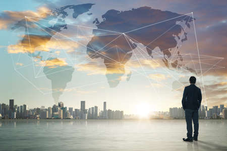 International business concept with businessman on city skyline background with network on map and sunlightの写真素材