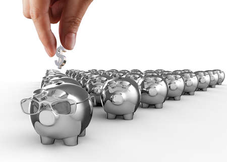 Saving, male hand putting a coin into piggy bank.の写真素材