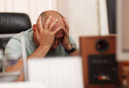 Middle-aged businessman in the office thinking about business problems