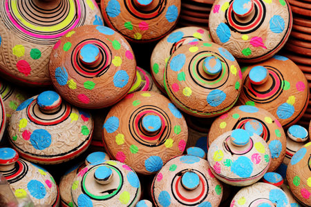 Colorful clay pottery for sale in a market, close upの写真素材