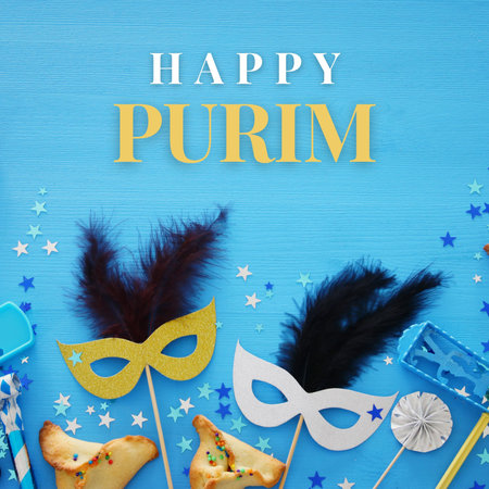 Purim celebration concept (Jewish carnival holiday) over blue wooden backgroundの写真素材