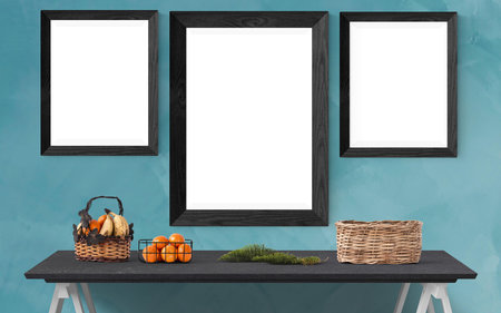 Wooden frame on the shelf with pumpkins, basket and basketの写真素材