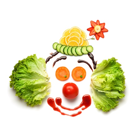 Happy meal for opponents of fast-food  A nice and funny edible clown, made of strawberries, lemons, salad and so on