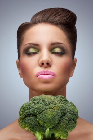 The cute photo of beauty with broccoli before the neck.の写真素材