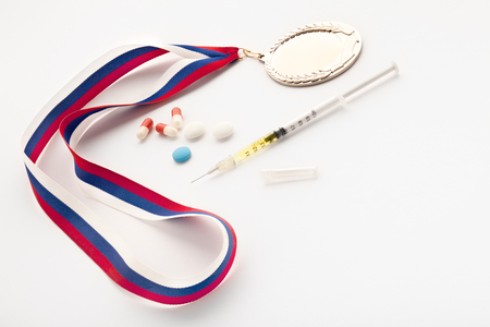 A set of a winner with a syringe, doping pills and a gold prize medal.の写真素材