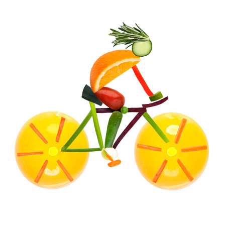 Fruits and vegetables in the shape of a male cyclist on a road bike