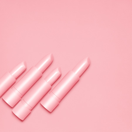 Creative still life of pink open lipsticks for makeup on pink background.の写真素材