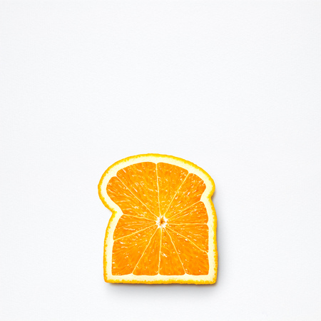 Healthy food concept and creative still life of bread slice made of fresh orange fruit.の写真素材