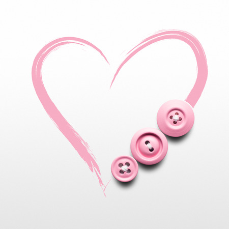 Creative valentines concept photo of buttons and illustrated heart on white background.